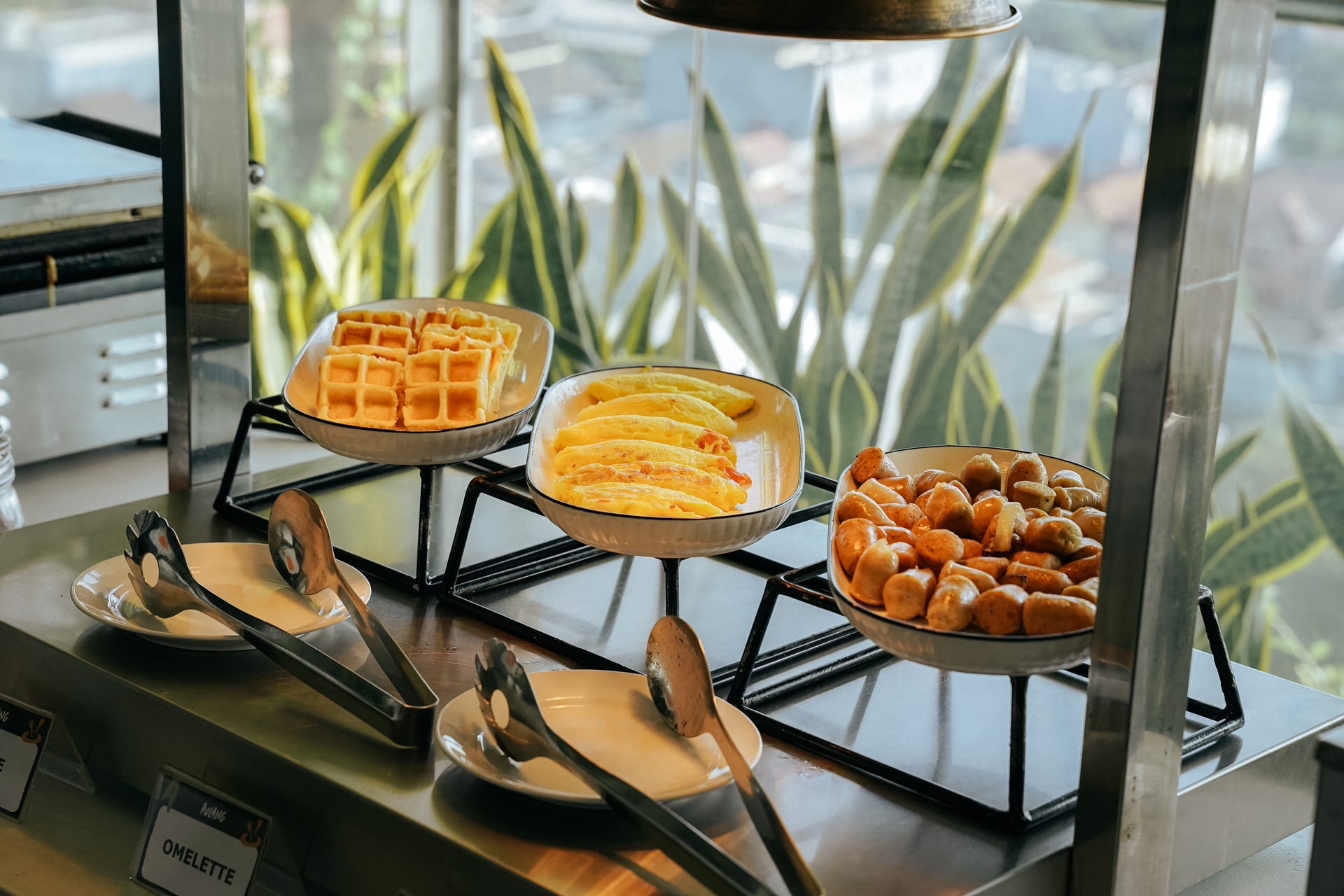 Waffles, omelettes and sausages on the warm buffet station at Alfresco Dining