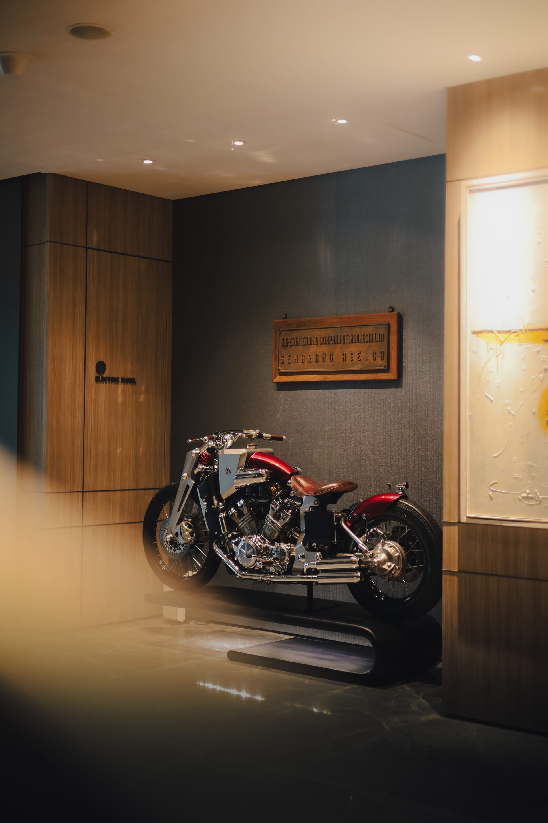 Handmade 1200cc Yamaha V-Max displayed beneath a wooden plaque in the PULANG ke UTTARA lobby